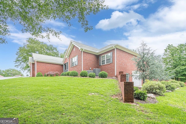 516 Main St, Hiram, GA 30141 - view of property exterior with brick siding, a lawn, and central AC unit
