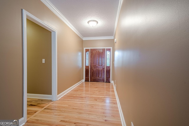 516 Main St, Hiram, GA 30141 - doorway to outside with light wood finished floors, a textured ceiling, crown molding, and baseboards