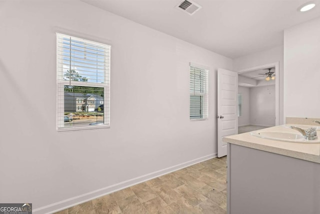 bathroom featuring a sink, baseboards, and a ceiling fan