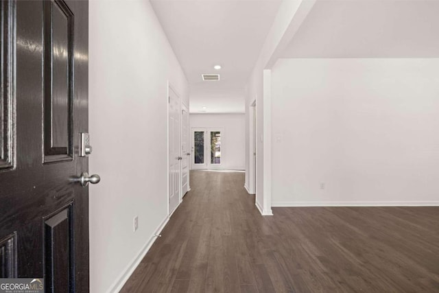 hallway featuring dark wood-style flooring, baseboards, and recessed lighting