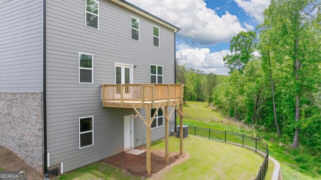 1473 Autumn Wind Dr, Dacula, GA 30019 - back of house featuring central AC and a wooden deck