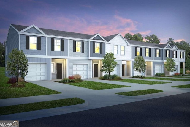 multi unit property with concrete driveway and a garage