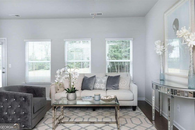 living area featuring baseboards and wood finished floors
