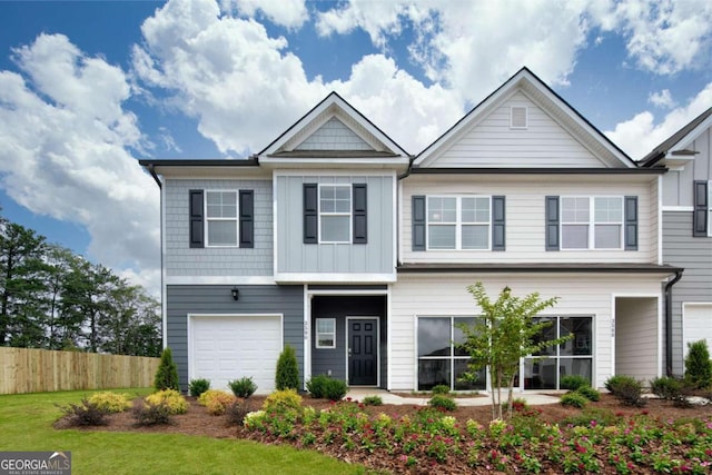 view of front facade featuring fence, a garage, and board and batten siding