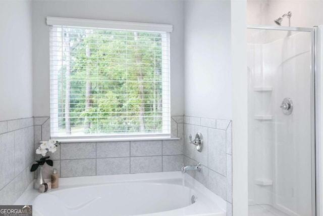 full bath featuring a shower stall and a garden tub