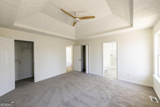 2192 Stenger Rd, Douglasville, GA 30135 - unfurnished bedroom with a raised ceiling, a textured ceiling, carpet, and baseboards
