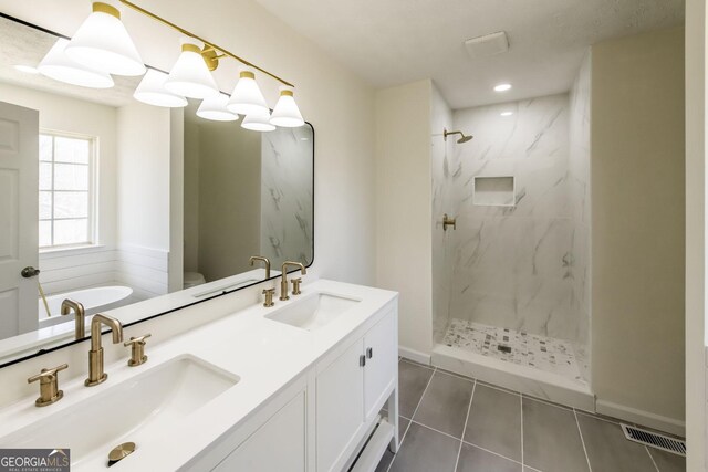 2192 Stenger Rd, Douglasville, GA 30135 - full bathroom with a marble finish shower, tile patterned flooring, double vanity, a tub, and recessed lighting
