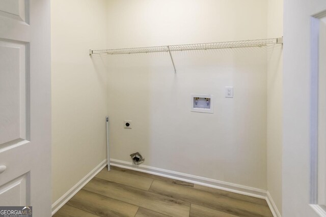 2192 Stenger Rd, Douglasville, GA 30135 - washroom featuring wood finished floors, hookup for an electric dryer, washer hookup, and baseboards