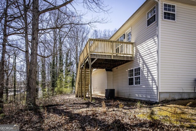 2192 Stenger Rd, Douglasville, GA 30135 - back of property with a wooden deck, stairway, and central AC