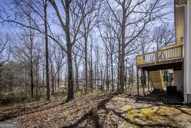 2192 Stenger Rd, Douglasville, GA 30135 - view of yard with stairway, a deck, and central air condition unit
