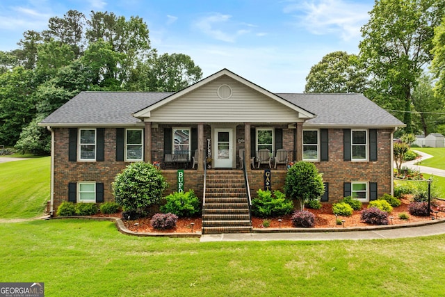 4010 Hamilton Mill Rd, Buford, GA 30519 - view of front of home with brick siding, a front yard, covered porch, and roof with shingles