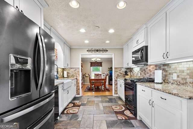 4010 Hamilton Mill Rd, Buford, GA 30519 - kitchen featuring black appliances, a sink, white cabinetry, recessed lighting, and stone finish floors