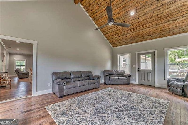 living room with high vaulted ceiling, ceiling fan, baseboards, wood ceiling, and wood finished floors