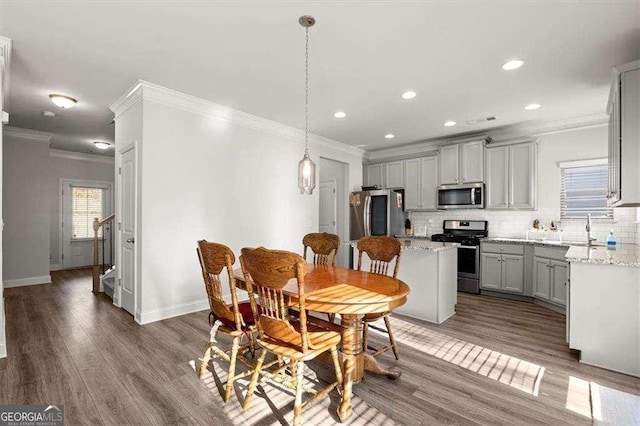 1511 Arica Ave, Lawrenceville, GA 30043 - dining space featuring crown molding, baseboards, recessed lighting, and wood finished floors