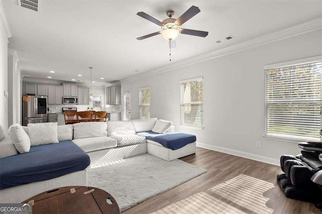 1511 Arica Ave, Lawrenceville, GA 30043 - living room with a ceiling fan, wood finished floors, crown molding, recessed lighting, and baseboards