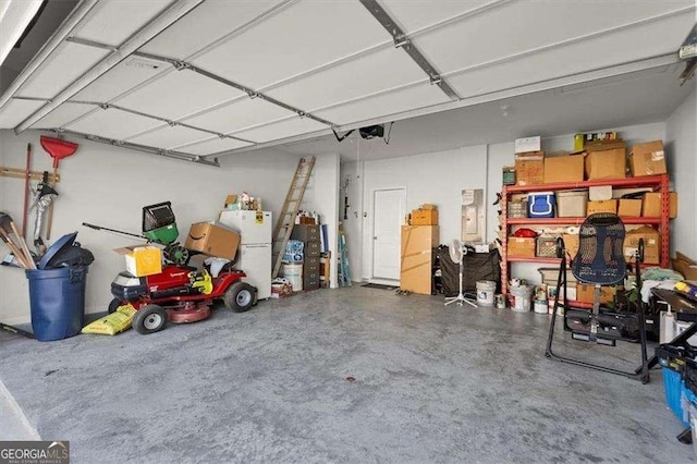 1511 Arica Ave, Lawrenceville, GA 30043 - garage featuring a garage door opener and freestanding refrigerator