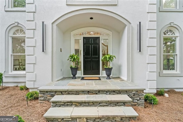 property entrance with stucco siding