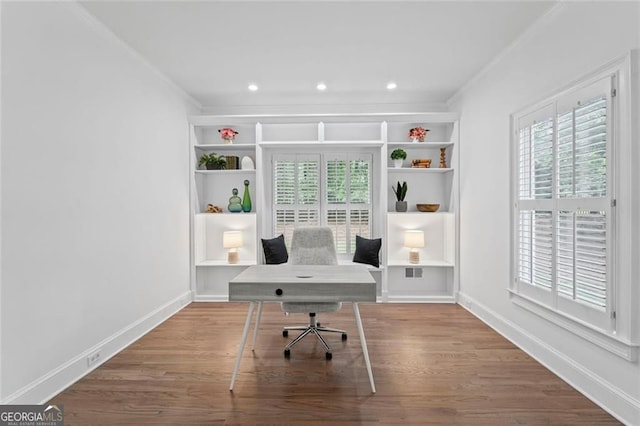 office featuring ornamental molding, plenty of natural light, wood finished floors, baseboards, and recessed lighting