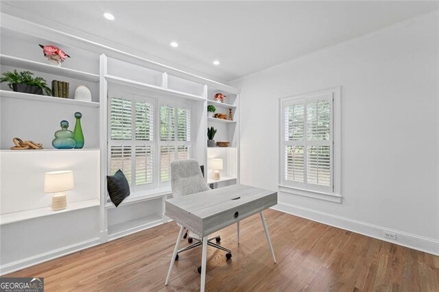 office featuring wood finished floors, healthy amount of natural light, baseboards, recessed lighting, and ornamental molding