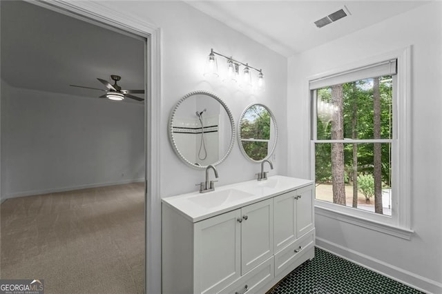 full bath with baseboards, a ceiling fan, and double vanity