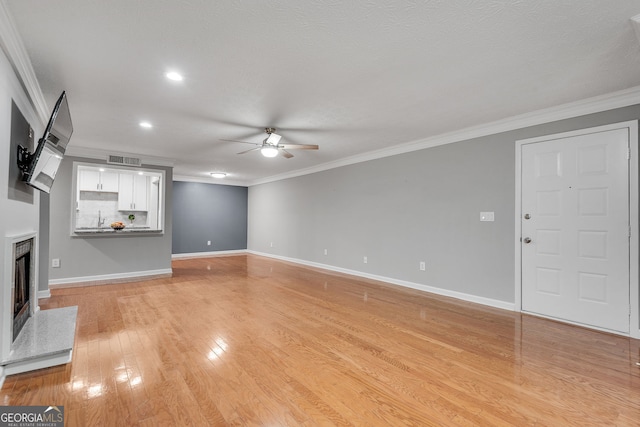 1015 Dunbar Dr, Dunwoody, GA 30338 - spare room featuring wood finished floors, built in shelves, baseboards, crown molding, and a textured ceiling