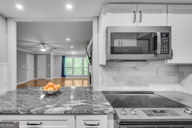 1015 Dunbar Dr, Dunwoody, GA 30338 - kitchen with stainless steel appliances, recessed lighting, white cabinets, baseboards, and light stone counters