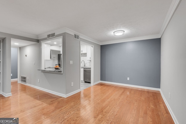 1015 Dunbar Dr, Dunwoody, GA 30338 - unfurnished living room with light wood-type flooring and crown molding