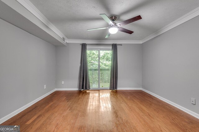 1015 Dunbar Dr, Dunwoody, GA 30338 - bedroom featuring light wood-type flooring, access to outside, crown molding, a textured ceiling, and a ceiling fan