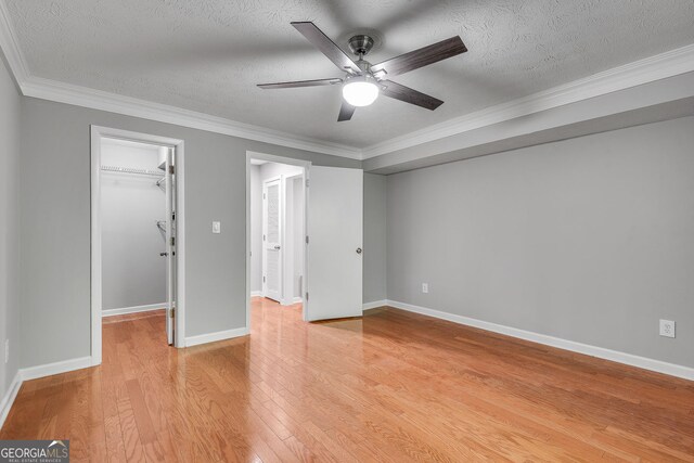 1015 Dunbar Dr, Dunwoody, GA 30338 - empty room with ceiling fan, wood finished floors, baseboards, a textured ceiling, and ornamental molding