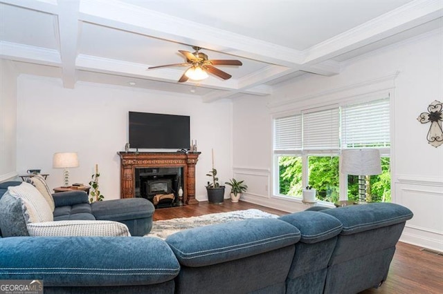 living room featuring coffered ceiling, dark wood-type flooring, beamed ceiling, ceiling fan, and crown molding