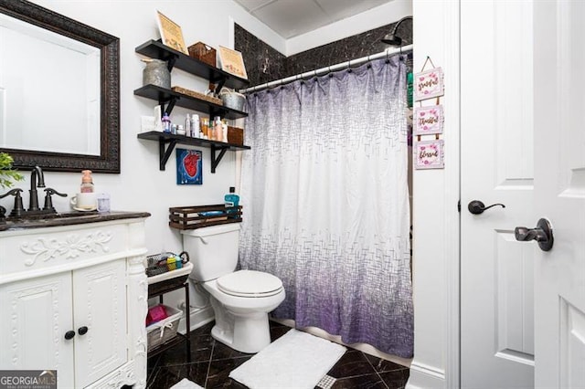 full bathroom with granite tiled floors, toilet, vanity, baseboards, and curtained shower