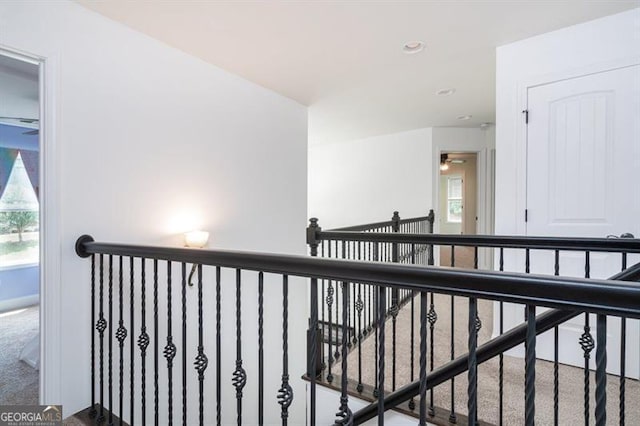 corridor featuring an upstairs landing, carpet, healthy amount of natural light, and recessed lighting