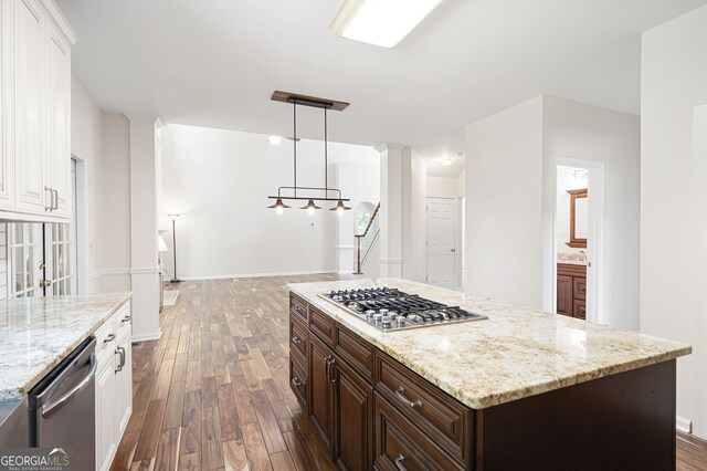 5034 Kingsbridge Pass, Powder Springs, GA 30127 - kitchen with appliances with stainless steel finishes, dark wood-style flooring, white cabinetry, dark brown cabinets, and light stone countertops