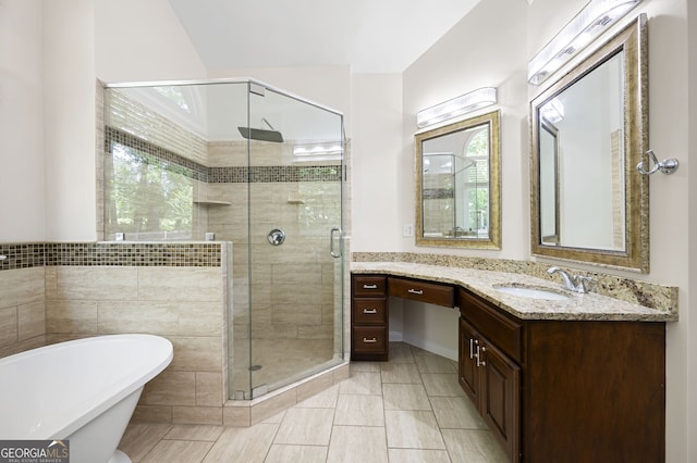 5034 Kingsbridge Pass, Powder Springs, GA 30127 - bathroom with vanity, a freestanding tub, and a stall shower