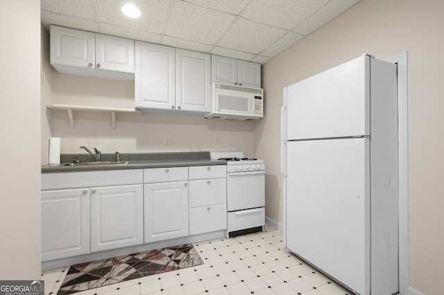 5034 Kingsbridge Pass, Powder Springs, GA 30127 - kitchen with white appliances, dark countertops, light flooring, white cabinetry, and a drop ceiling