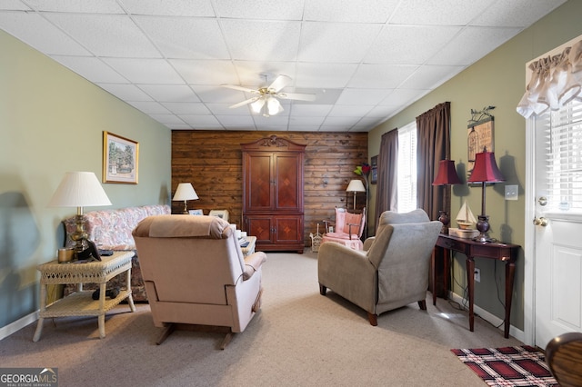 5034 Kingsbridge Pass, Powder Springs, GA 30127 - living area featuring light carpet, ceiling fan, a drop ceiling, baseboards, and wood walls