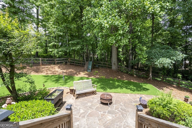 5034 Kingsbridge Pass, Powder Springs, GA 30127 - view of yard with an outdoor fire pit, a patio, and a garden