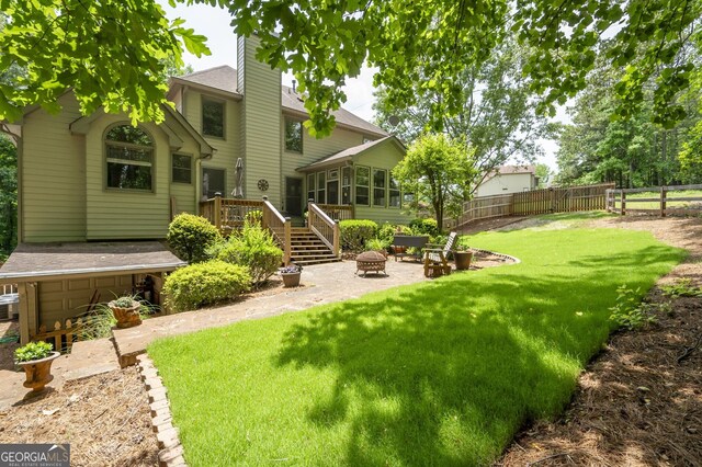 5034 Kingsbridge Pass, Powder Springs, GA 30127 - back of house with an outdoor fire pit, a wooden deck, a chimney, a sunroom, and stairway