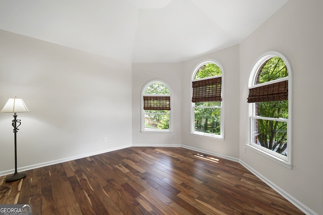 5034 Kingsbridge Pass, Powder Springs, GA 30127 - unfurnished room with dark wood-type flooring, lofted ceiling, and baseboards