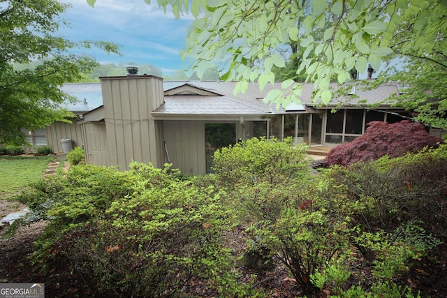 3353 Greenfield Dr, Marietta, GA 30068 - view of side of home with a chimney, a sunroom, and a shingled roof