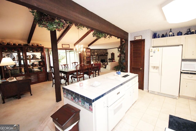 3353 Greenfield Dr, Marietta, GA 30068 - kitchen with white appliances, tile counters, a chandelier, and white cabinets