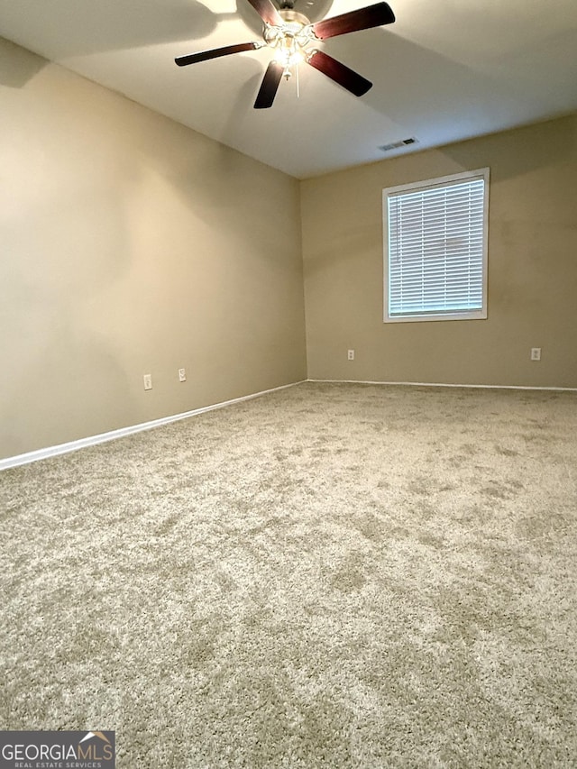 empty room with carpet flooring and baseboards