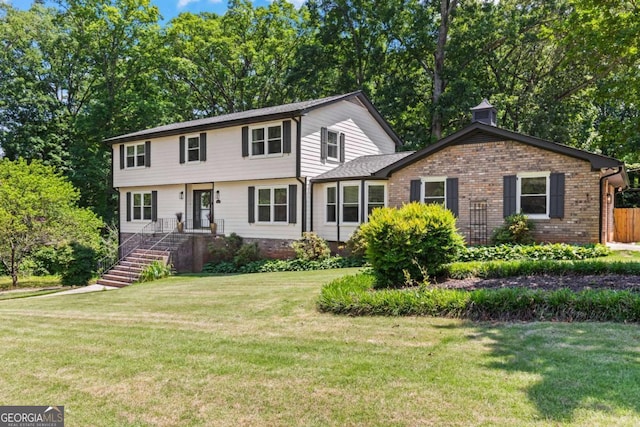 3441 Sherrod Dr SW, Marietta, GA 30060 - view of front of property featuring a front lawn, brick siding, and view of wooded area