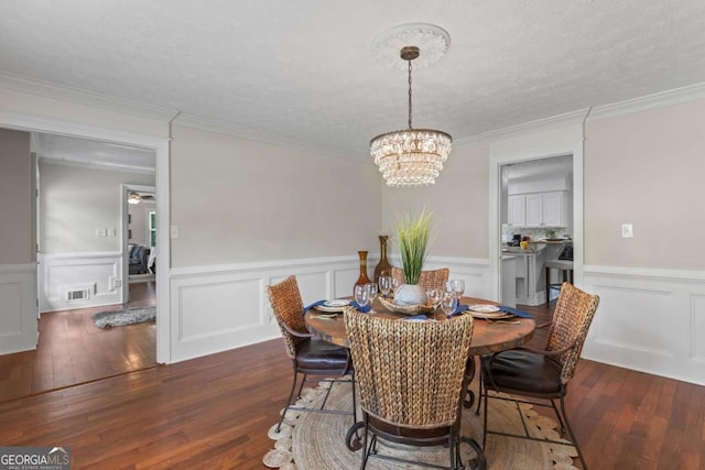 3441 Sherrod Dr SW, Marietta, GA 30060 - dining area with a chandelier, wainscoting, dark wood finished floors, ornamental molding, and a decorative wall