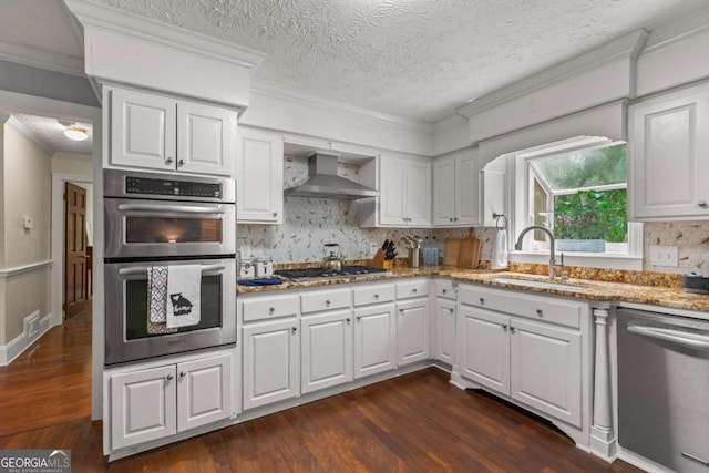 3441 Sherrod Dr SW, Marietta, GA 30060 - kitchen featuring stainless steel appliances, a sink, wall chimney range hood, dark wood finished floors, and tasteful backsplash