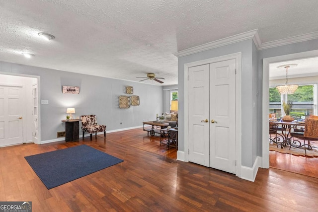 3441 Sherrod Dr SW, Marietta, GA 30060 - foyer entrance featuring a textured ceiling, wood finished floors, a ceiling fan, a chandelier, and baseboards