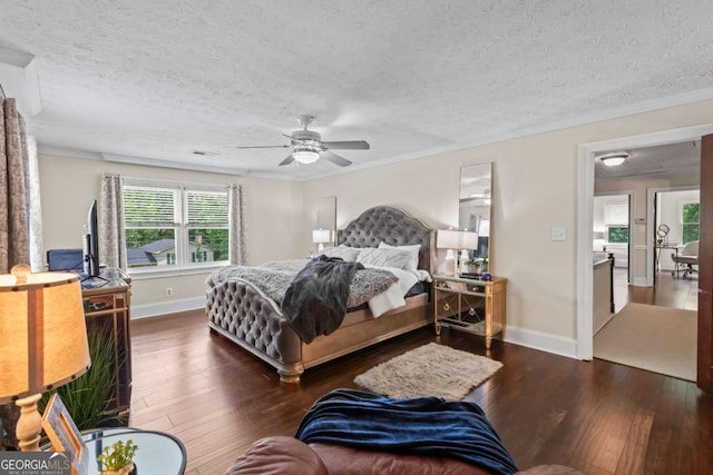 3441 Sherrod Dr SW, Marietta, GA 30060 - bedroom featuring a textured ceiling, dark wood-type flooring, baseboards, and a ceiling fan
