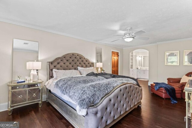 3441 Sherrod Dr SW, Marietta, GA 30060 - bedroom with arched walkways, dark wood-style flooring, crown molding, a ceiling fan, and connected bathroom