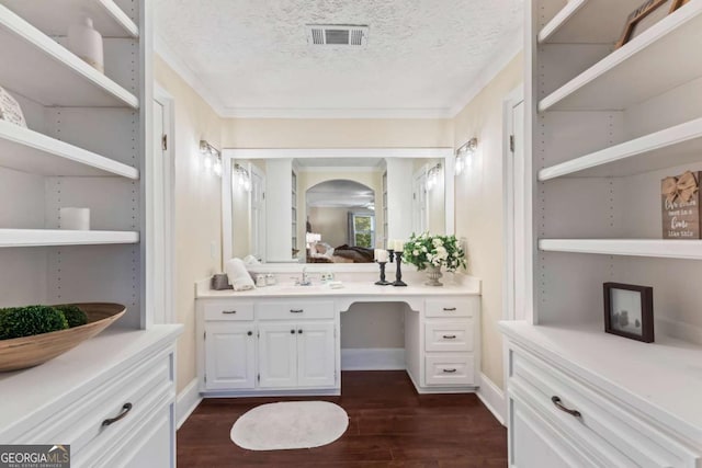 3441 Sherrod Dr SW, Marietta, GA 30060 - ensuite bathroom featuring wood finished floors, crown molding, vanity, a textured ceiling, and baseboards