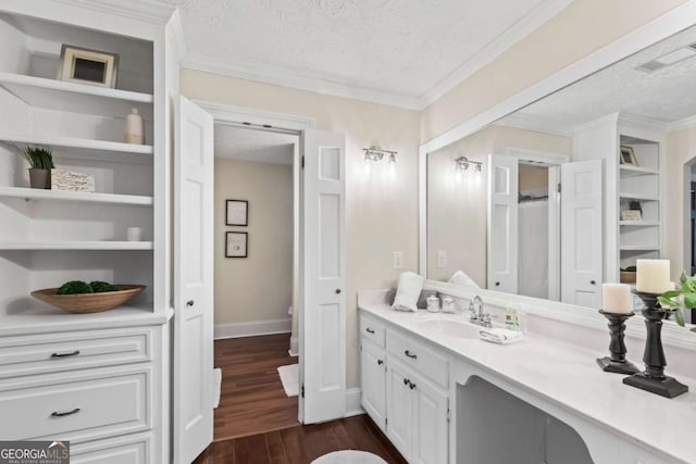 3441 Sherrod Dr SW, Marietta, GA 30060 - bathroom with a textured ceiling, wood finished floors, vanity, baseboards, and ornamental molding